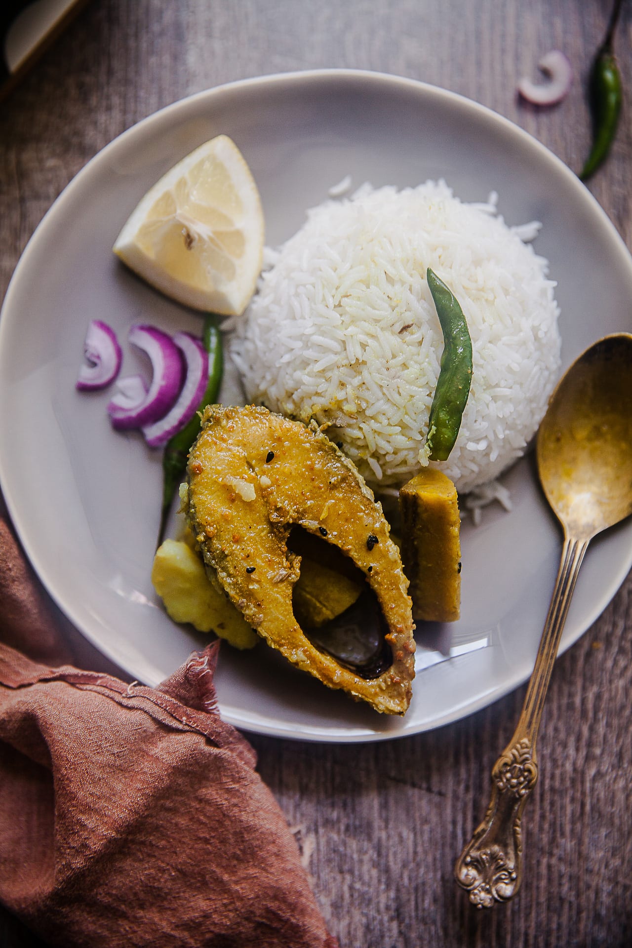 Ilish Maach Kacha Kola Jhol - A Bengali style fish curry with plantain and potato. Very mild and not spicy #bengali #fishcurry #Ilish #maach #indian #plantain #jhol