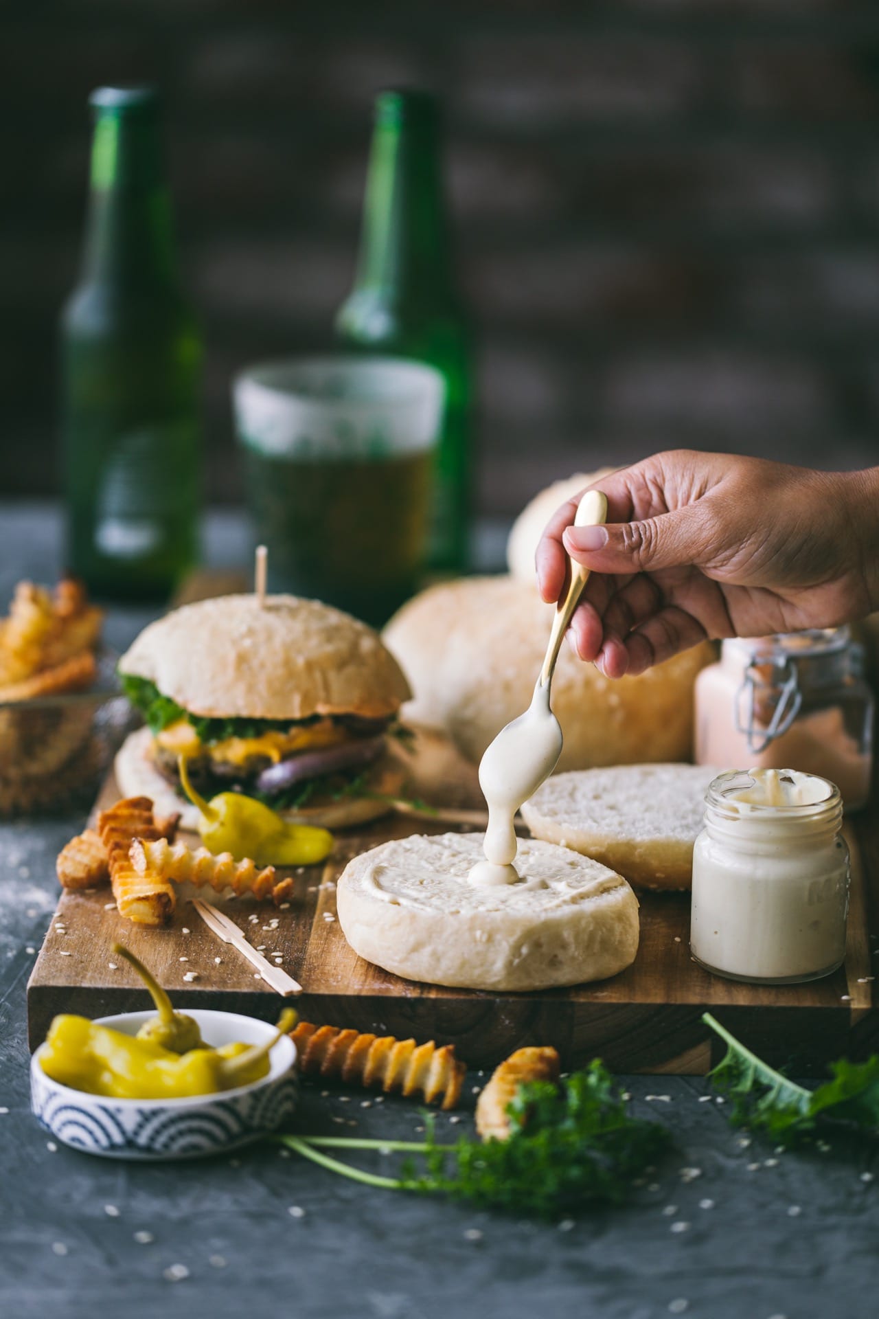 Pouring mayo on bun #foodphotography #foodstyling #burgerbuns #eggless #baking 