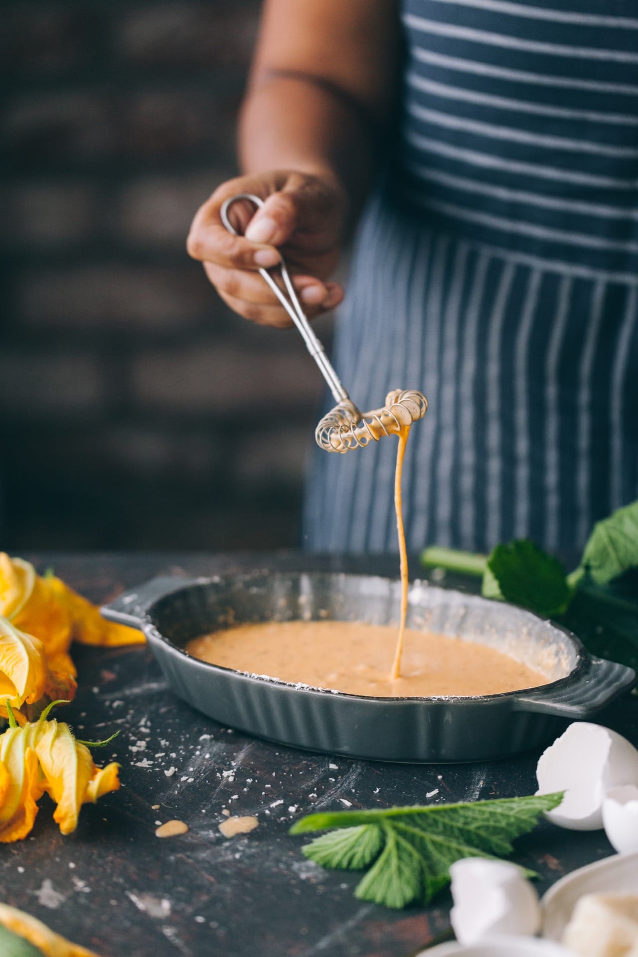 Whisking the light batter for the zucchini blossoms fritters