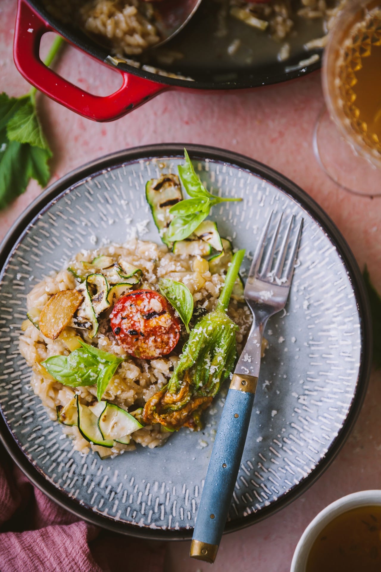 Summer risotto served on a small plate.